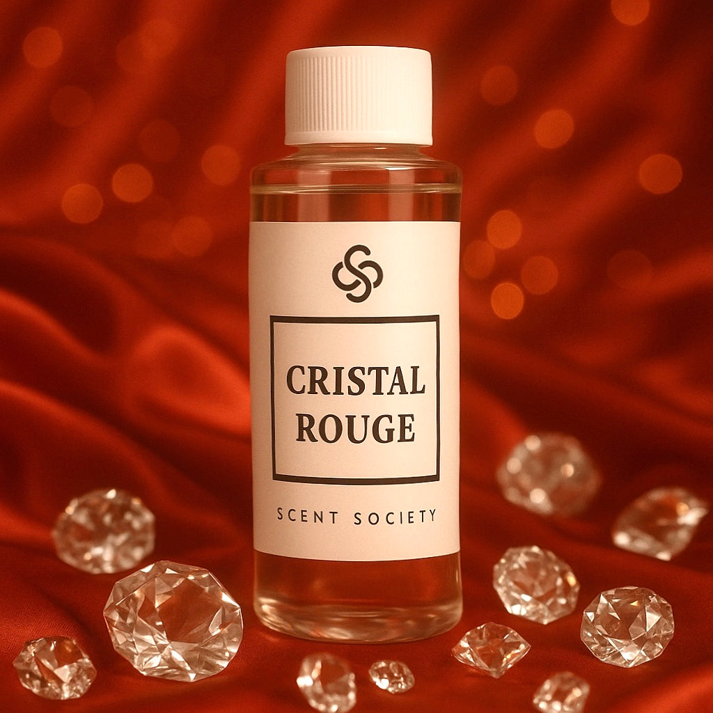 Luxury Cristal Rouge diffuser oil bottle by Scent Society displayed on red silk fabric with sparkling crystal gems, elegant home fragrance inspired by Baccarat Rouge.