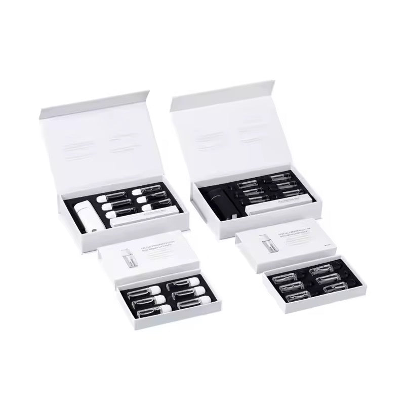 Four Sets of white and black Scent Society car vent scent oil diffusers, fragrance oils and accessories in open boxes on a white background