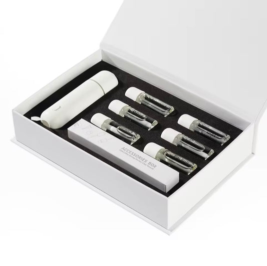 Set of white car clip fragrance diffuser with six diffuser oils and accessories in a box on a white background
