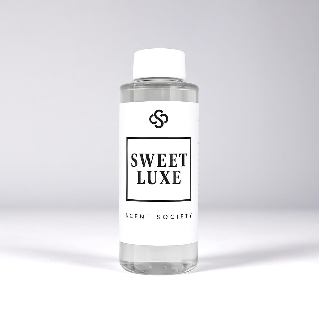 Scent Society diffuser fragrance oil in clear 100ml bottle labeled Sweet Luxe, with white cap on neutral background.