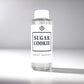 Clear diffuser oil bottle labeled 'Sugar Cookie' by Scent Society on a gray background