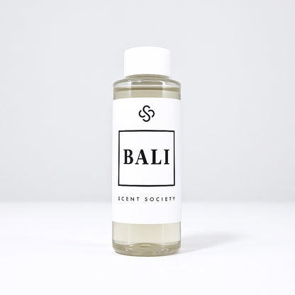Scent Society diffuser fragrance oil in clear 100ml bottle labeled Bali, with white cap on neutral background.