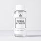 Scent Society diffuser fragrance oil in clear 100ml bottle labeled Turks & Caicos, with white cap on neutral background.