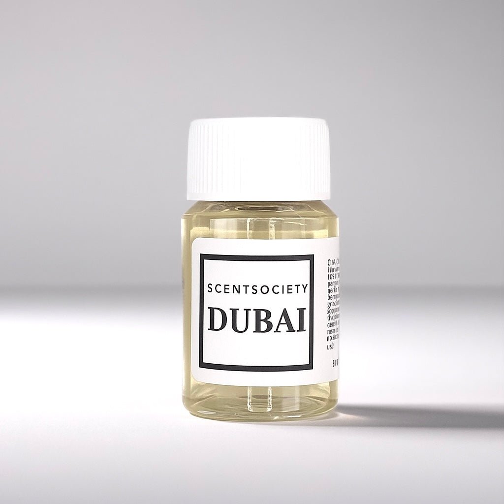 20ml bottle of Scent Society labeled 'DUBAI' diffuser oil on a neutral background. Clear plastic bottle with white cap and minimalist black-and-white label, filled with fragrance oil. Aromatherapy oil for use in cold air diffusers.