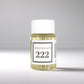 20ml bottle of Scent Society labeled '222' diffuser oil on a neutral background. Clear plastic bottle with white cap and minimalist black-and-white label, filled with fragrance oil. Aromatherapy oil for use in cold air diffusers.