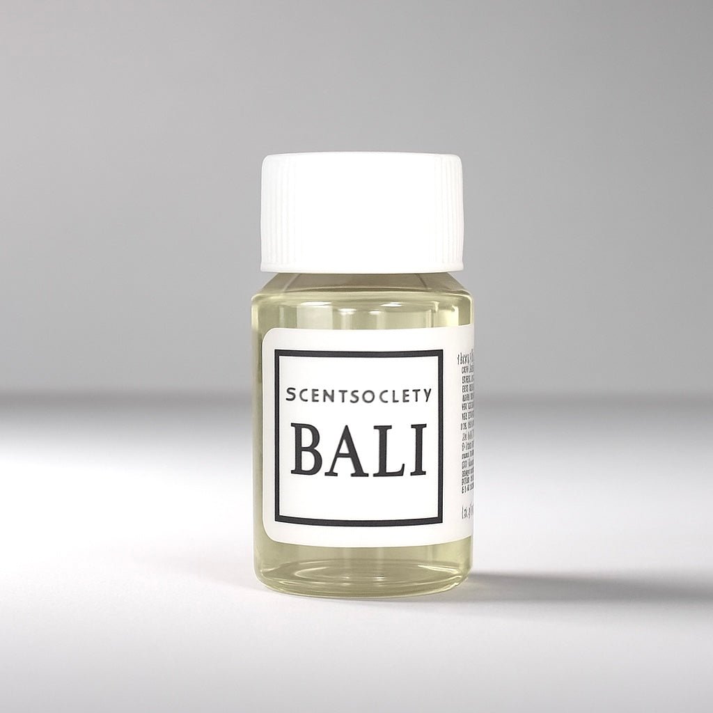 20ml bottle of Scent Society labeled 'BALI' diffuser oil on a neutral background. Clear plastic bottle with white cap and minimalist black-and-white label, filled with fragrance oil. Aromatherapy oil for use in cold air diffusers.