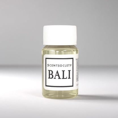 20ml bottle of Scent Society labeled 'BALI' diffuser oil on a neutral background. Clear plastic bottle with white cap and minimalist black-and-white label, filled with fragrance oil. Aromatherapy oil for use in cold air diffusers.