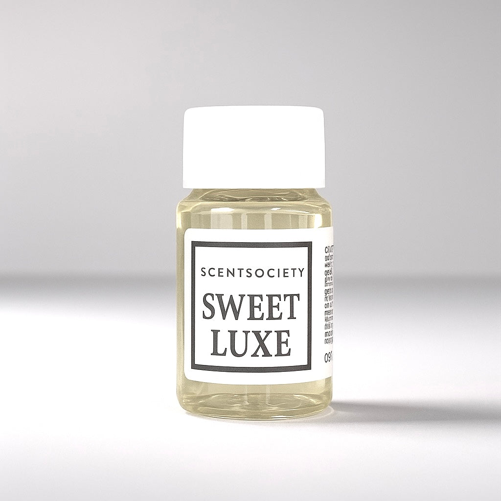 20ml bottle of Scent Society labeled 'SWEET LUXE' diffuser oil on a neutral background. Clear plastic bottle with white cap and minimalist black-and-white label, filled with fragrance oil. Aromatherapy oil for use in cold air diffusers.