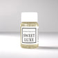 20ml bottle of Scent Society labeled 'SWEET LUXE' diffuser oil on a neutral background. Clear plastic bottle with white cap and minimalist black-and-white label, filled with fragrance oil. Aromatherapy oil for use in cold air diffusers.