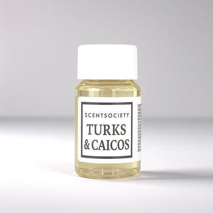 20ml bottle of Scent Society labeled 'TURKS & CAICOS' diffuser oil on a neutral background. Clear plastic bottle with white cap and minimalist black-and-white label, filled with fragrance oil. Aromatherapy oil for use in cold air diffusers.