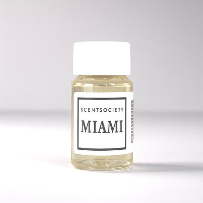 20ml bottle of Scent Society labeled 'MIAMI' diffuser oil on a neutral background. Clear plastic bottle with white cap and minimalist black-and-white label, filled with fragrance oil. Aromatherapy oil for use in cold air diffusers.