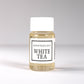 20ml bottle of Scent Society labeled 'WHITE TEA' diffuser oil on a neutral background. Clear plastic bottle with white cap and minimalist black-and-white label, filled with fragrance oil. Aromatherapy oil for use in cold air diffusers.