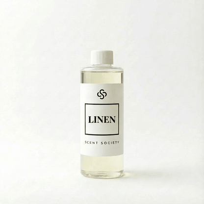 Scent Society Linen diffuser oil bottle with clear glass, minimalist label, and white background