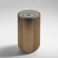 Scent Society Intro compact gold diffuser with vertical ribbed texture, flat circular top, and LED indicator lights, shown standing upright on a neutral background for desktop or small space scenting.