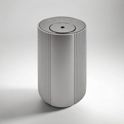 Scent Society Intro compact silver diffuser with vertical ribbed texture, flat circular top, and LED indicator lights, shown standing upright on a neutral background for desktop or small space scenting.