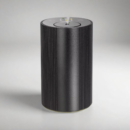 Scent Society Intro compact black diffuser with vertical ribbed texture, flat circular top, and LED indicator lights, shown standing upright on a neutral background for desktop or small space scenting.