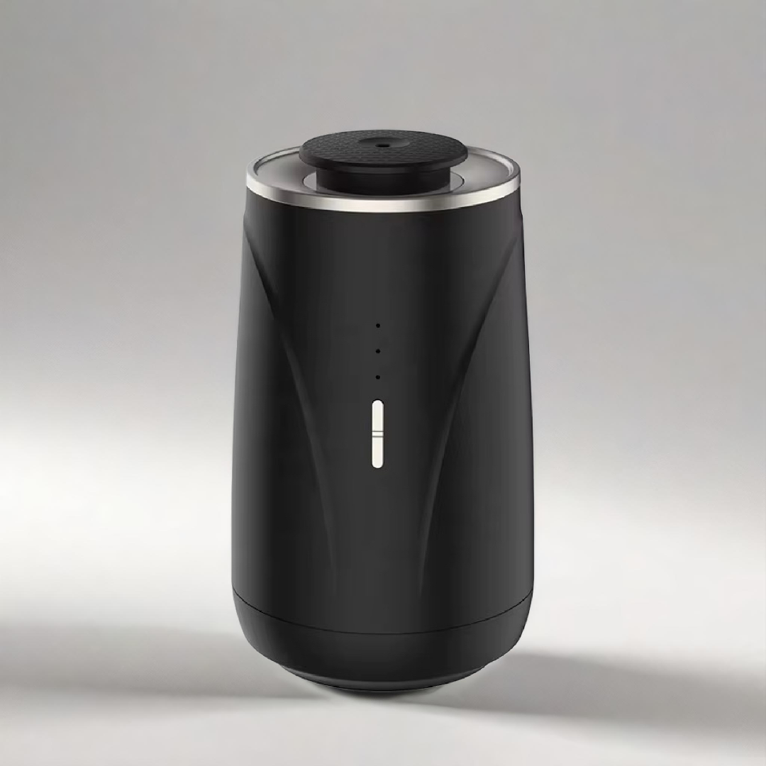 Scent Society VALET black prtable car diffuser with a sleek matte finish, minimalist LED indicator, and metallic rim, displayed on a light background.