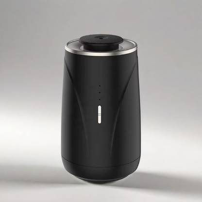 Scent Society VALET black prtable car diffuser with a sleek matte finish, minimalist LED indicator, and metallic rim, displayed on a light background.