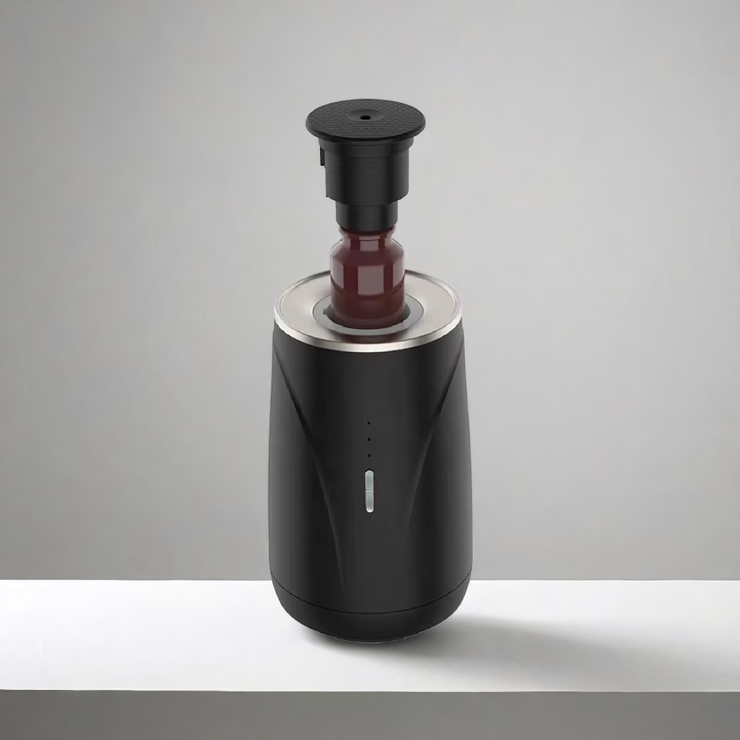 Scent Society Valet black portable car diffuser shown open with a glass fragrance oil bottle inserted vertically, featuring a matte finish, LED indicator lights, and metallic trim, displayed on a neutral background.