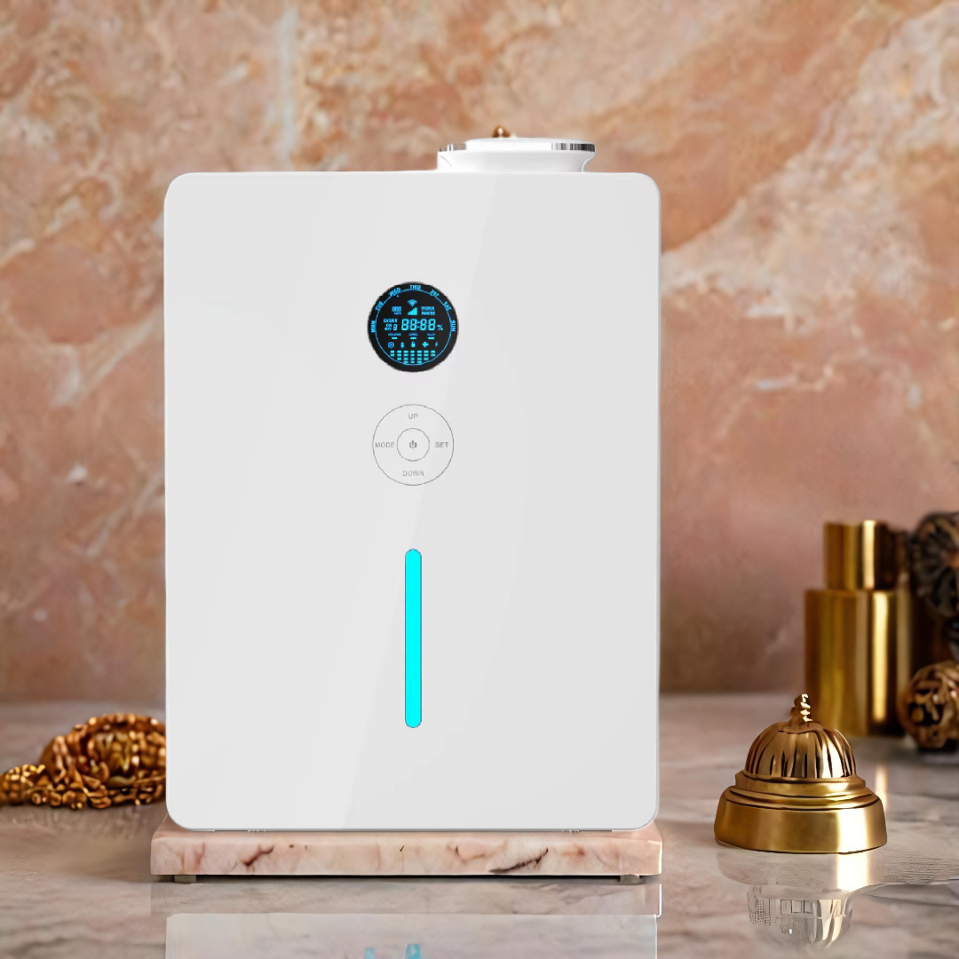 White rectangular scent diffuser with digital LED display, control panel, and vertical teal light, displayed on a marble surface with gold hotel bell and accessories - luxury fragrance diffuser for large spaces or hospitality settings.