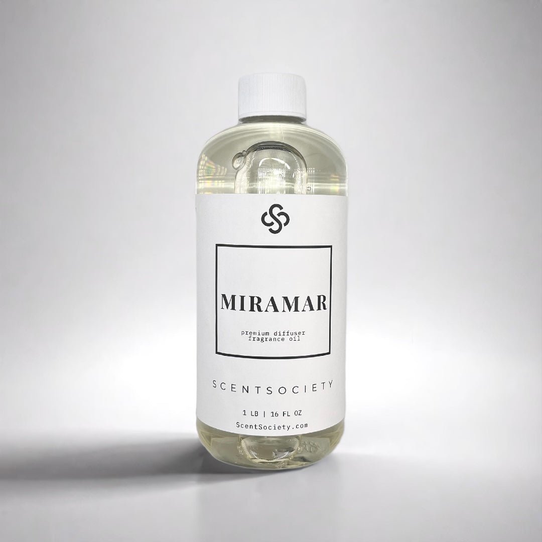 1LB bottle of Scent Society labeled 'MIRAMAR' diffuser oil on a neutral background. Clear plastic bottle with white cap and minimalist black-and-white label, filled with fragrance oil. Aromatherapy oil for use in cold air diffusers.
