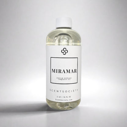 1LB bottle of Scent Society labeled 'MIRAMAR' diffuser oil on a neutral background. Clear plastic bottle with white cap and minimalist black-and-white label, filled with fragrance oil. Aromatherapy oil for use in cold air diffusers.