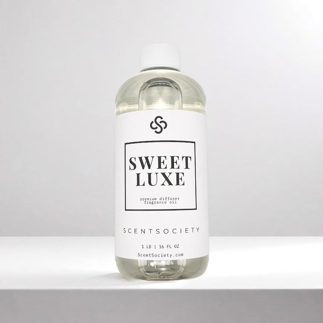 Scent Society diffuser fragrance oil in clear 500ml bottle labeled Sweet Luxe, with white cap on neutral background.