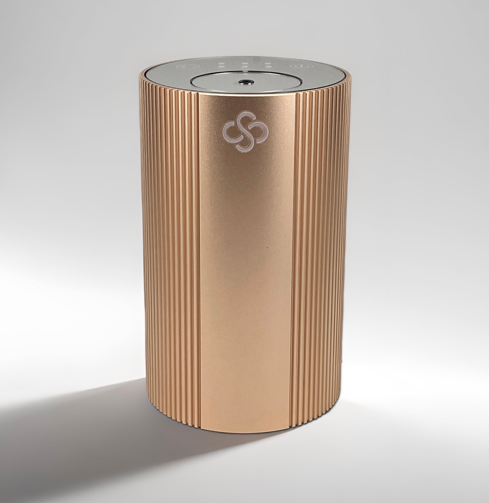 Gold cylindrical Scent Society Entrance Scent Diffuser device with a mirror top on a white background