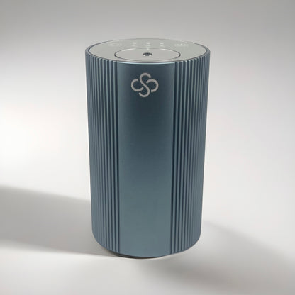 Slate Gray cylindrical Scent Society Entrance Scent Diffuser device with a mirror control top on a white background