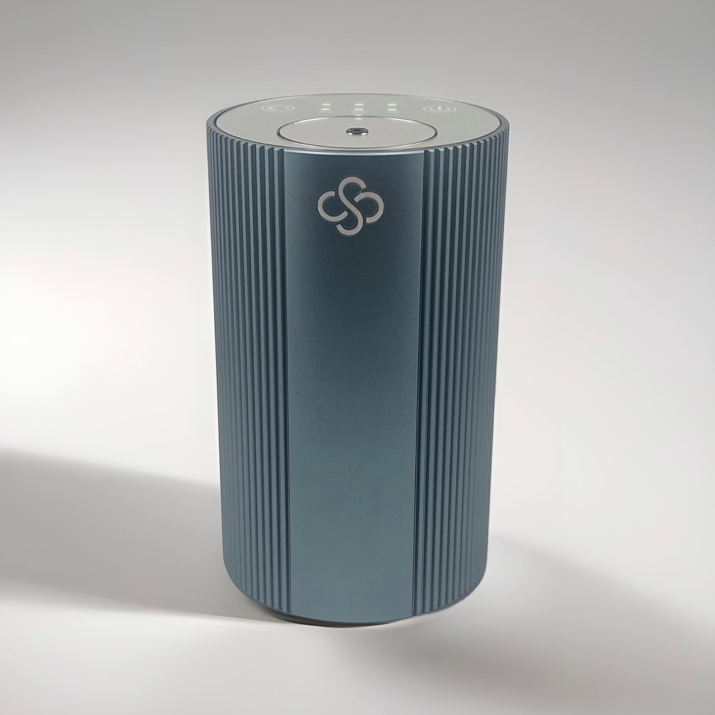 Slate Gray cylindrical Scent Society Entrance Scent Diffuser device with a mirror control top on a white background