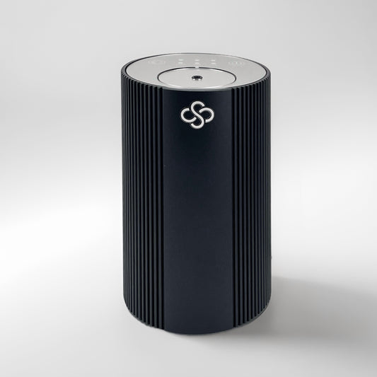 Black cylindrical Scent Society Entrance Scent Diffuser device with a mirror control top on a white background