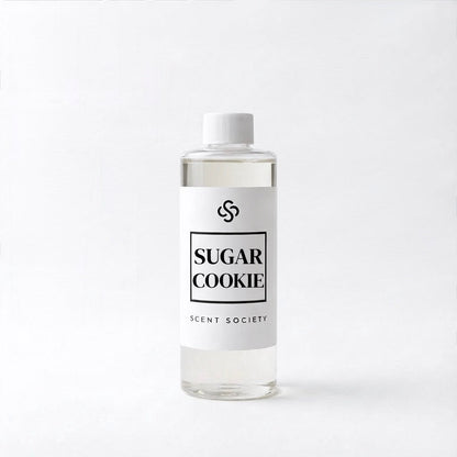 Bottle of 'Sugar Cookie' diffuser oil fragrance by Scent Society on a white background